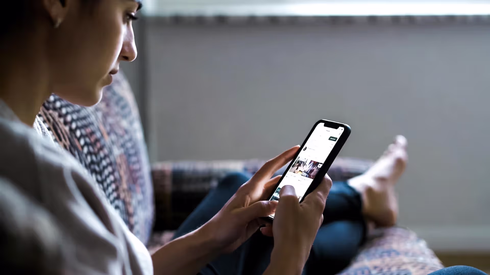 Person scrolling social media and feeling anxious about others’ success