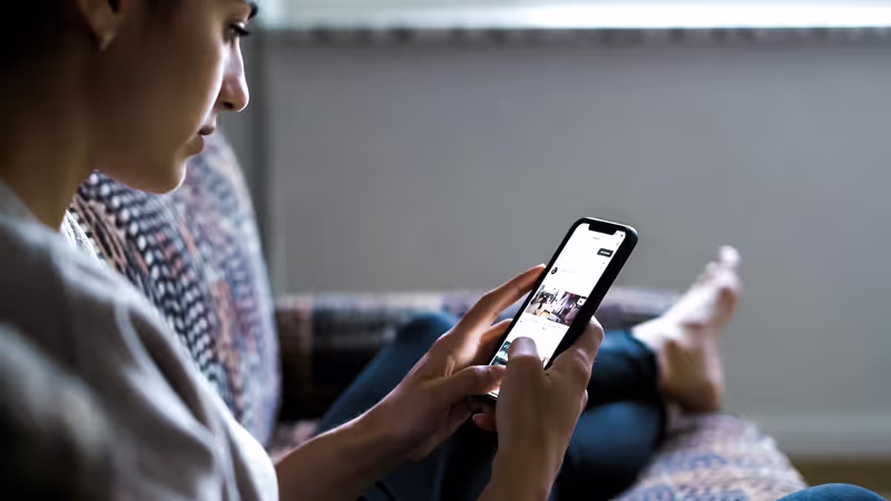 Person scrolling social media and feeling anxious about others’ success