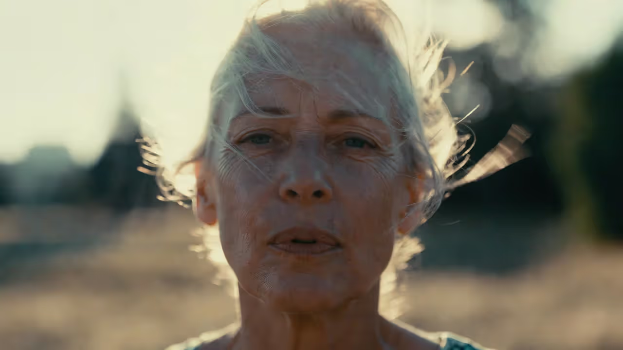 Adult standing outdoors in soft sunlight with calm expression symbolizing emotional reconnection